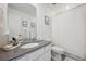 Bathroom with gray countertops, white cabinets, and shower with a curtain at 700 Lillibrook Pl, Erie, CO 80026