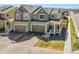 Attractive two-story home with gray siding, two-car garage, and charming covered porch at 700 Lillibrook Pl, Erie, CO 80026