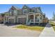 Charming exterior of home with a welcoming front porch, well-manicured lawn, and attached garage at 700 Lillibrook Pl, Erie, CO 80026