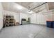 Clean garage with epoxy floors, storage cabinets, and ample space for parking at 700 Lillibrook Pl, Erie, CO 80026