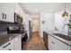 Contemporary kitchen boasts stainless steel appliances, white cabinets, and a sleek countertop at 700 Lillibrook Pl, Erie, CO 80026