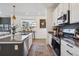 Elegant kitchen with stainless steel appliances, a kitchen island, and natural light at 700 Lillibrook Pl, Erie, CO 80026