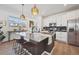 Bright kitchen features a central island, stainless steel appliances, and modern pendant lighting at 700 Lillibrook Pl, Erie, CO 80026
