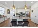 Gourmet kitchen with island, stainless steel appliances, white cabinets and breakfast bar at 700 Lillibrook Pl, Erie, CO 80026