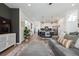 Open layout showcasing the living room, dining area, and kitchen with modern finishes at 700 Lillibrook Pl, Erie, CO 80026