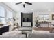 Open-concept living room with lots of light, a decorative wall, and modern furnishings at 700 Lillibrook Pl, Erie, CO 80026