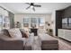 Bright living room features a comfortable gray couch, large windows and stylish decor at 700 Lillibrook Pl, Erie, CO 80026