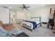 Bright main bedroom featuring neutral colors, a ceiling fan, and view of the neighborhood at 700 Lillibrook Pl, Erie, CO 80026