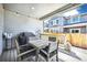 Cozy covered patio has a table, chairs, grill, and string lights, perfect for outdoor dining and entertaining at 700 Lillibrook Pl, Erie, CO 80026