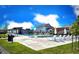 Community pool with lounge chairs, umbrellas, and clear skies in a planned neighborhood at 700 Lillibrook Pl, Erie, CO 80026