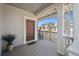 Inviting covered porch featuring a rocking chair, stylish decor, and wood-look flooring at 700 Lillibrook Pl, Erie, CO 80026