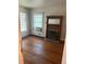 Bedroom showcasing hardwood floors, a fireplace, and a window AC unit at 1901 N Emerson St, Denver, CO 80218