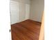 Bedroom featuring hardwood floors, radiator, and a double door closet at 1901 N Emerson St, Denver, CO 80218