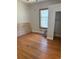 Bedroom featuring hardwood floors, a window, and closet space at 1901 N Emerson St, Denver, CO 80218
