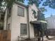 Exterior elevation of a two-story home featuring ivy and glass block windows at 1901 N Emerson St, Denver, CO 80218