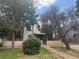 Charming two-story home with mature trees and a well-maintained lawn at 1901 N Emerson St, Denver, CO 80218