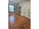 Spacious living room features hardwood floors, a window, and built in shelves at 1901 N Emerson St, Denver, CO 80218