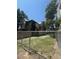 Backyard view with grass and gravel, surrounded by a chain link fence at 1901 N Emerson St, Denver, CO 80218