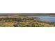 Wide aerial perspective of a community showing open space with trees, lake, and beach at 13894 E Lehigh Ave # G, Aurora, CO 80014