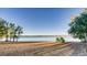 Sandy beach area with trees nearby leading up to a tranquil lake with clear skies at 13894 E Lehigh Ave # G, Aurora, CO 80014