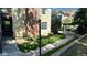 Two story condo with brick and siding, lush lawn, and a pergola covered walkway at 13894 E Lehigh Ave # G, Aurora, CO 80014