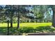 Green space outside of home with a retaining wall, grassy area, trees and a path at 13894 E Lehigh Ave # G, Aurora, CO 80014