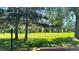 Picturesque greenspace featuring mature trees, manicured grass, and open skies, creating a serene and inviting atmosphere at 13894 E Lehigh Ave # G, Aurora, CO 80014