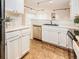 Kitchen view highlighting the cabinetry, countertops, and the natural light coming from adjacent room at 13894 E Lehigh Ave # G, Aurora, CO 80014