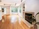 An airy living space featuring wood floors, fireplace, and natural light from the sliding glass door at 13894 E Lehigh Ave # G, Aurora, CO 80014