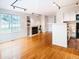 Bright living room with hardwood floors, fireplace, and large window overlooking the yard at 13894 E Lehigh Ave # G, Aurora, CO 80014