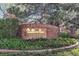 Meadow Hills brick signage surrounded by manicured bushes and a large tree at 13894 E Lehigh Ave # G, Aurora, CO 80014
