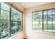 A serene view from the room's windows, showcasing lush greenery and a mature tree at 13894 E Lehigh Ave # G, Aurora, CO 80014