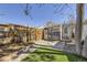 Landscaped backyard with a paver patio, mature tree, grass, and a wooden fence provides a private outdoor space at 1157 N Downing St, Denver, CO 80218
