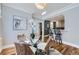 The dining room has hardwood floors, a round table, and a view into the kitchen at 1157 N Downing St, Denver, CO 80218