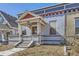 This home features a covered porch, painted brick, and an inviting entryway at 1157 N Downing St, Denver, CO 80218