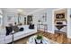 This living room features wood floors, an opening to the bedroom, and contemporary decor at 1157 N Downing St, Denver, CO 80218