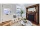 This cozy living room has a fireplace, wood floors, a bright window, and modern chairs at 1157 N Downing St, Denver, CO 80218