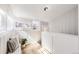 Bright sunroom featuring white walls, tile floor, multiple windows, and a cozy bench with pillows at 1157 N Downing St, Denver, CO 80218