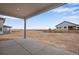 Covered patio overlooking a large backyard and surrounding landscape at 3432 N Gold Bug Ct, Aurora, CO 80019