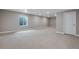 Spacious finished basement with neutral carpeting and large window at 3432 N Gold Bug Ct, Aurora, CO 80019