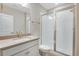 Modern bathroom with white tile, a glass shower, and updated vanity at 3432 N Gold Bug Ct, Aurora, CO 80019