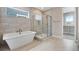 Spa-like bathroom featuring a soaking tub and a walk-in shower at 3432 N Gold Bug Ct, Aurora, CO 80019