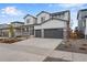 Two-story home with gray siding, stone accents and three car garage at 3432 N Gold Bug Ct, Aurora, CO 80019