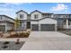 Two-story home with gray siding, stone accents and three car garage at 3432 N Gold Bug Ct, Aurora, CO 80019