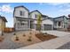 Two-story house with gray siding, stone accents, and a landscaped front yard at 3432 N Gold Bug Ct, Aurora, CO 80019