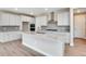 Modern kitchen with white cabinets, quartz countertops, and stainless steel appliances at 3432 N Gold Bug Ct, Aurora, CO 80019