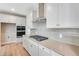 Modern kitchen with white cabinets, quartz countertops, and stainless steel appliances at 3432 N Gold Bug Ct, Aurora, CO 80019