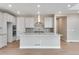 Modern kitchen with white cabinets, quartz countertops, and stainless steel appliances at 3432 N Gold Bug Ct, Aurora, CO 80019