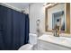 Updated bathroom featuring modern vanity, shower with a blue curtain at 8666 Mariposa St, Thornton, CO 80260