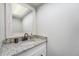 Powder room with granite counters, updated faucet and fixtures, and white vanity at 8666 Mariposa St, Thornton, CO 80260